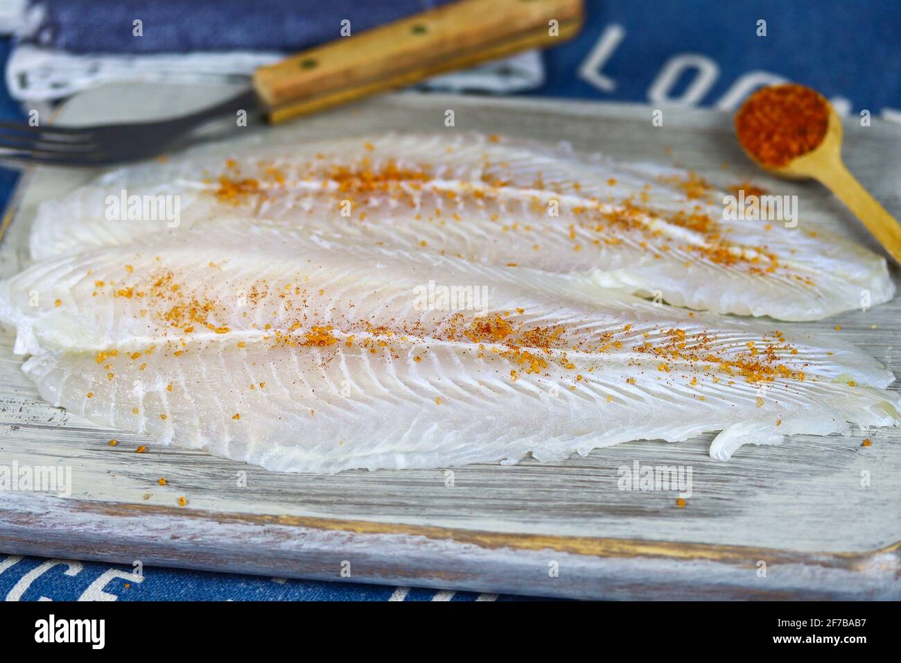 raw flounder fillet on a wooden board Stock Photo Alamy