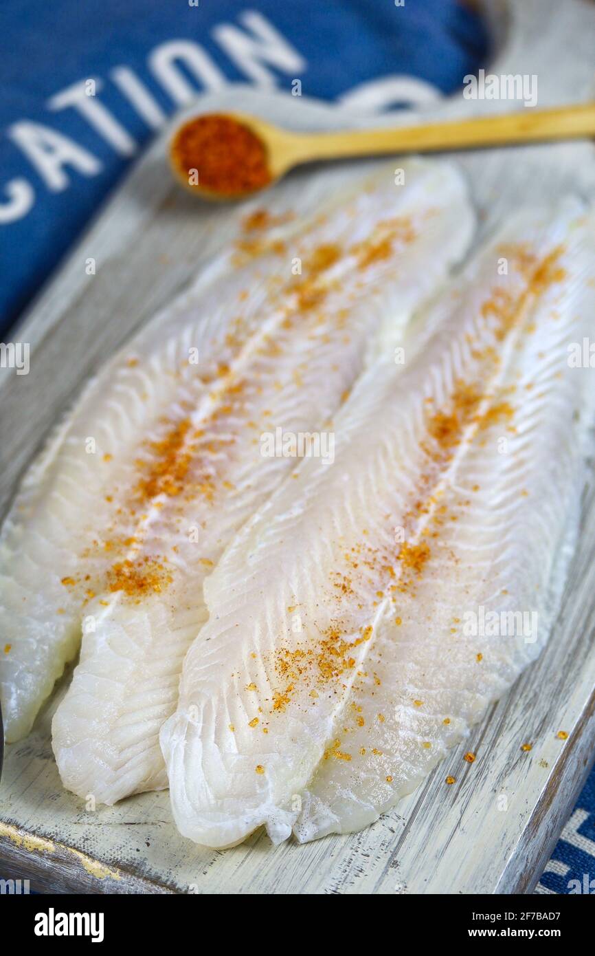 raw flounder fillet on a wooden board Stock Photo Alamy