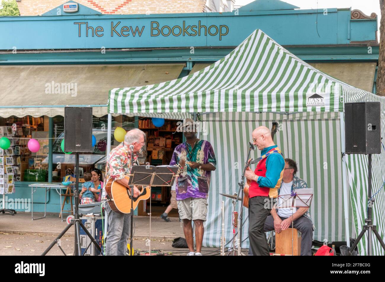 A band playing at the Sunday market outside the Kew Bookshop in Kew village, London. Stock Photo