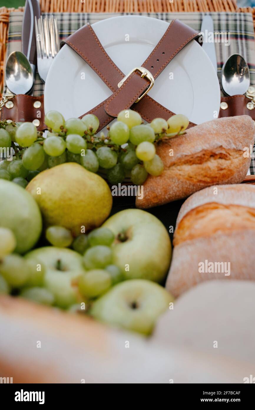 Picnic basket with cutlery and white plates for family lunch Stock ...