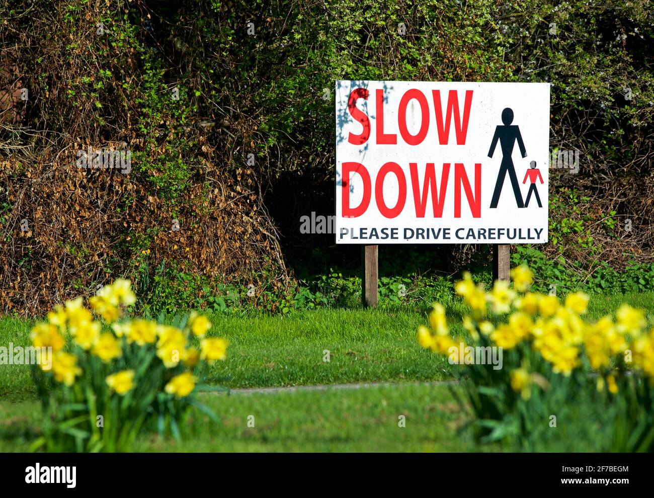 Sign requesting drivers to slow down through village, England UK Stock Photo