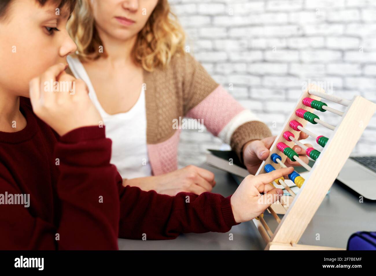 Side view of boy learning to count with an abacus Stock Photo