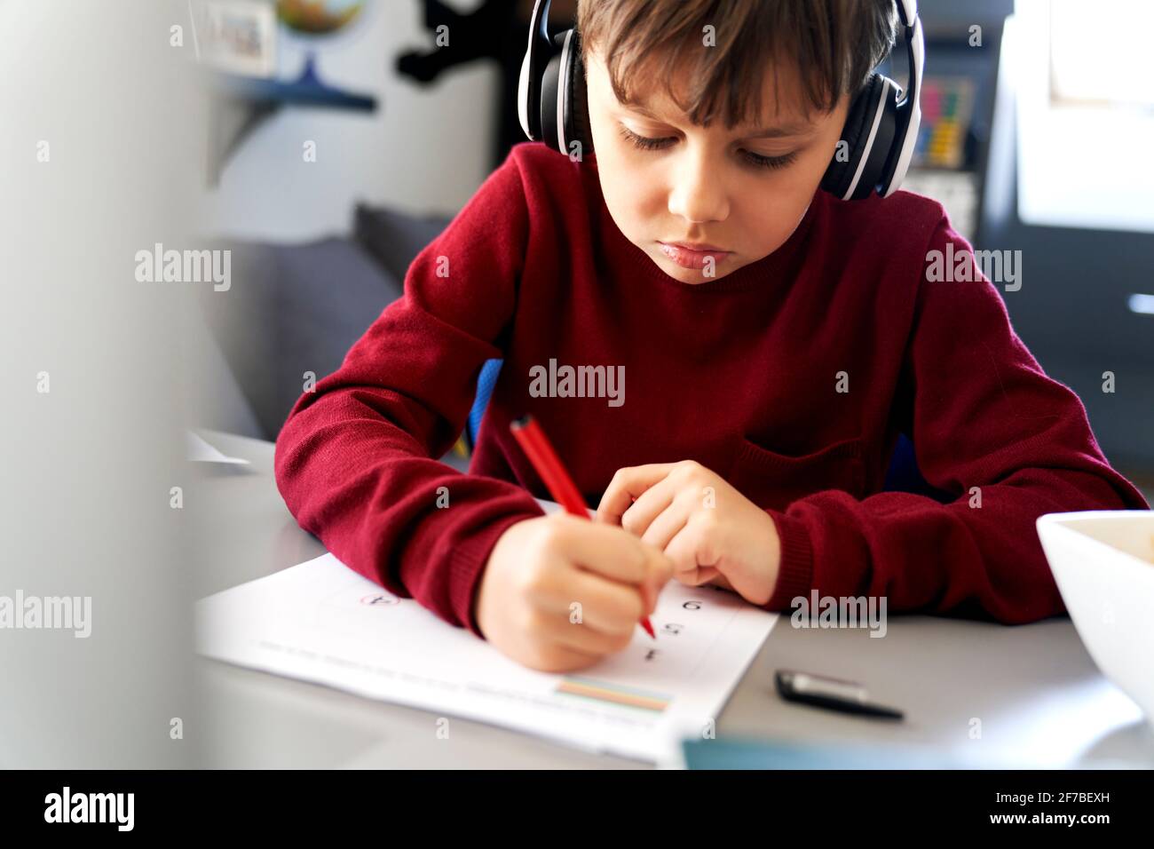 Close up of boy doing homework during a lockdown Stock Photo