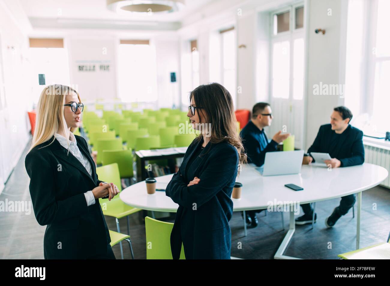 Two Businesswomen Having Informal Meeting In Modern Office Stock Photo ...