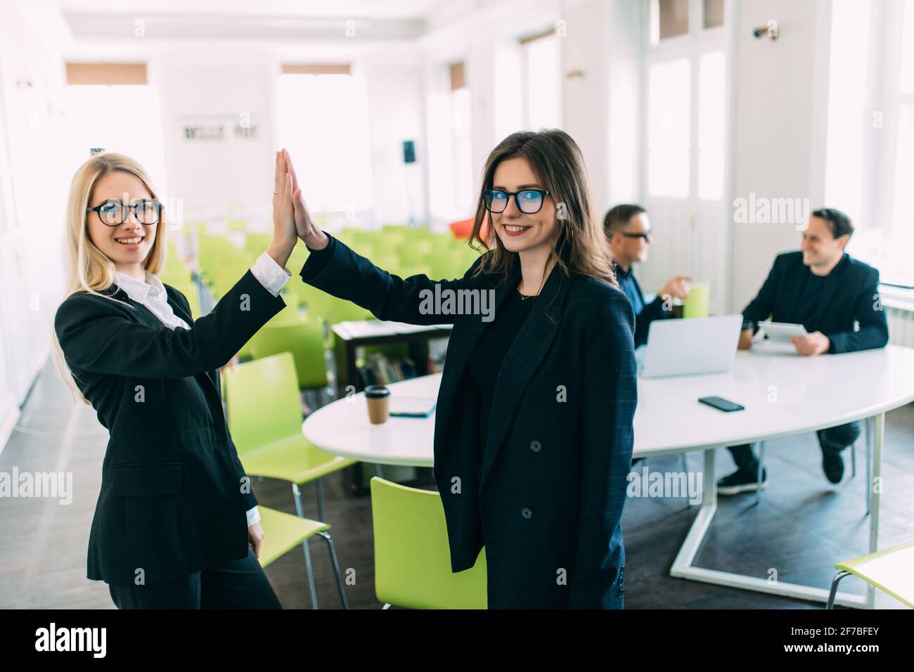 members of the business team giving each other a high five Stock Photo ...