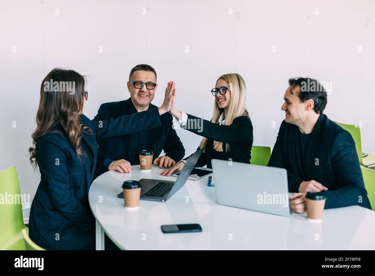 Business people giving each other high five and clapping. Business team ...
