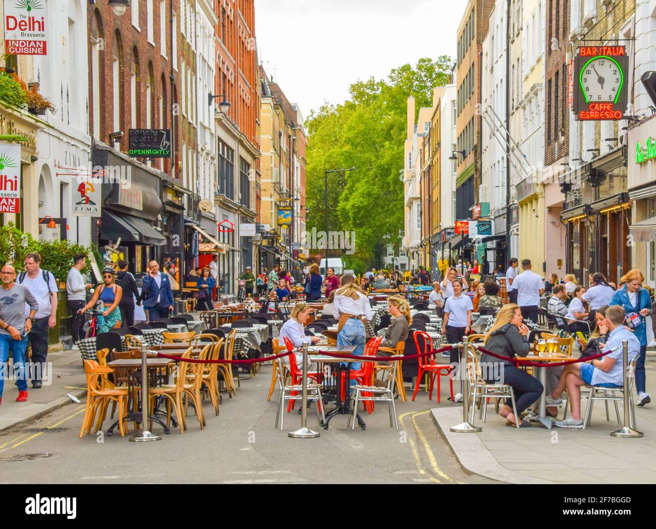 Crowd of people in Frith Street, Soho. Temporary al fresco street seating was implemented to allow bars and restaurants to operate and facilitate social distancing during the coronavirus pandemic. London, United Kingdom, 21st August 2020. Stock Photo