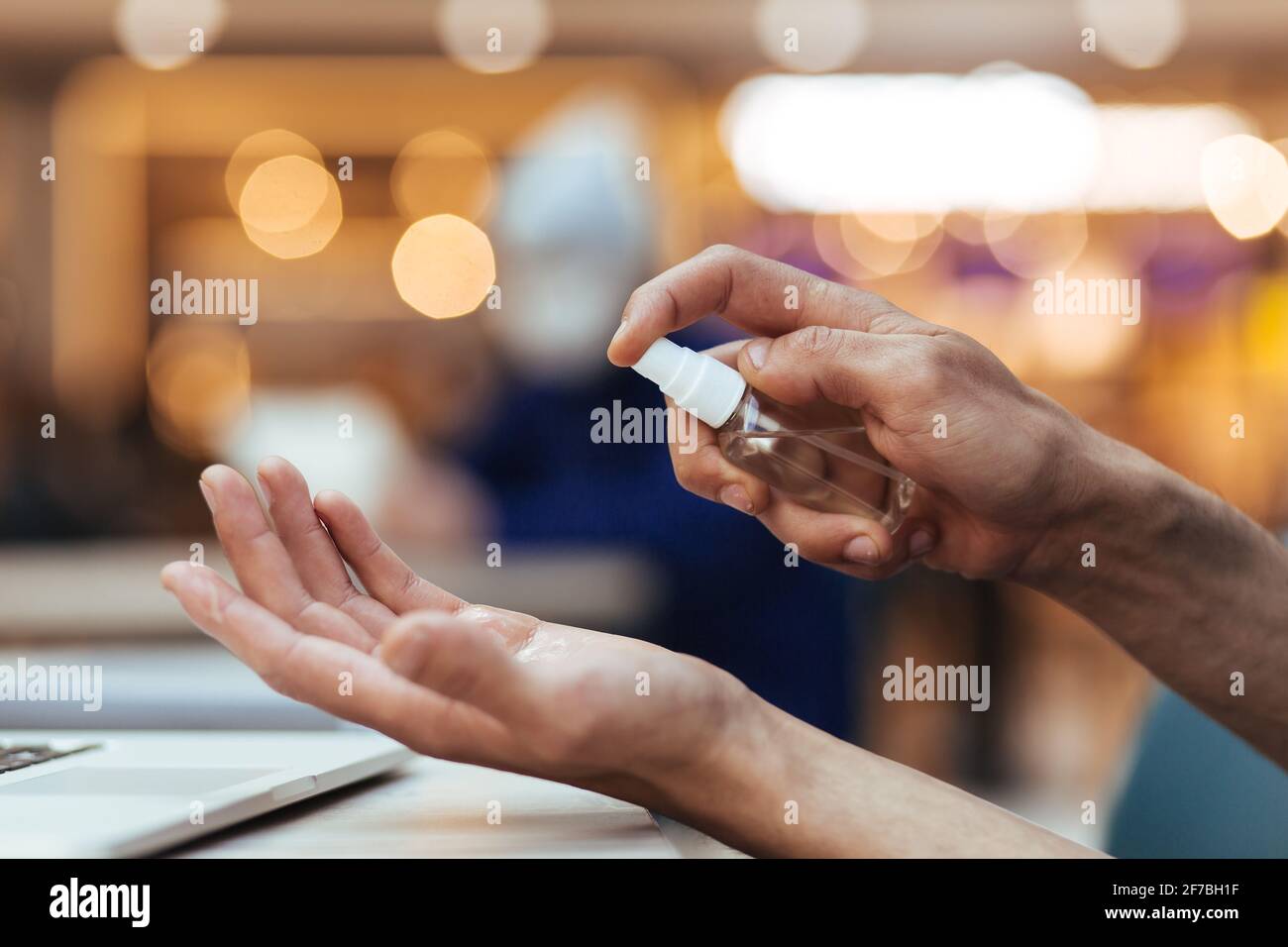close up. man uses an antiseptic hand spray Stock Photo Alamy