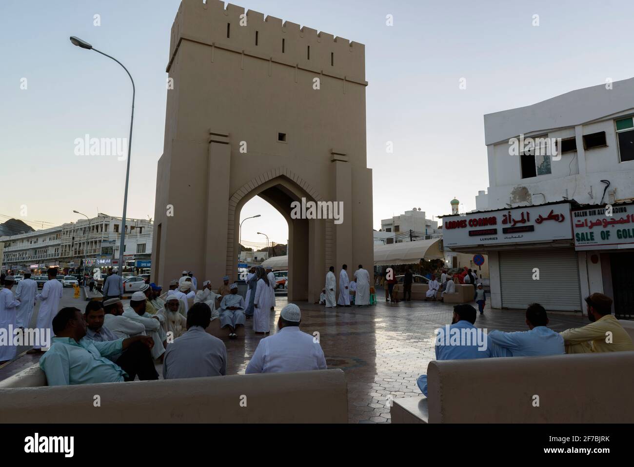Men socialising after a hot day in the city center of Muscat near the Mutrah souk, Oman. Stock Photo