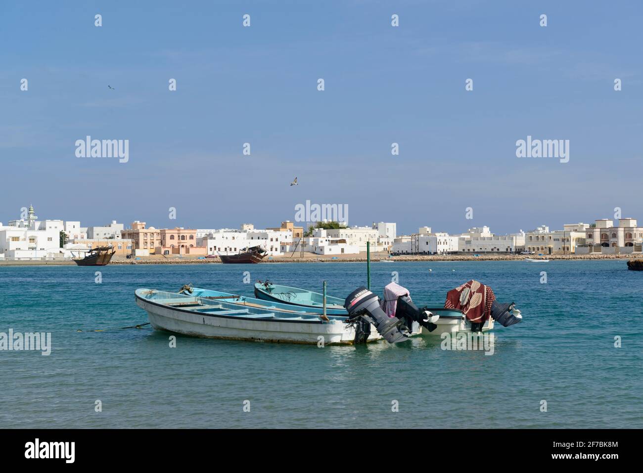 Fishing boats and dhows in the lagoon between the village Aylah (that you can see here) and the city Sur, Oman. Stock Photo