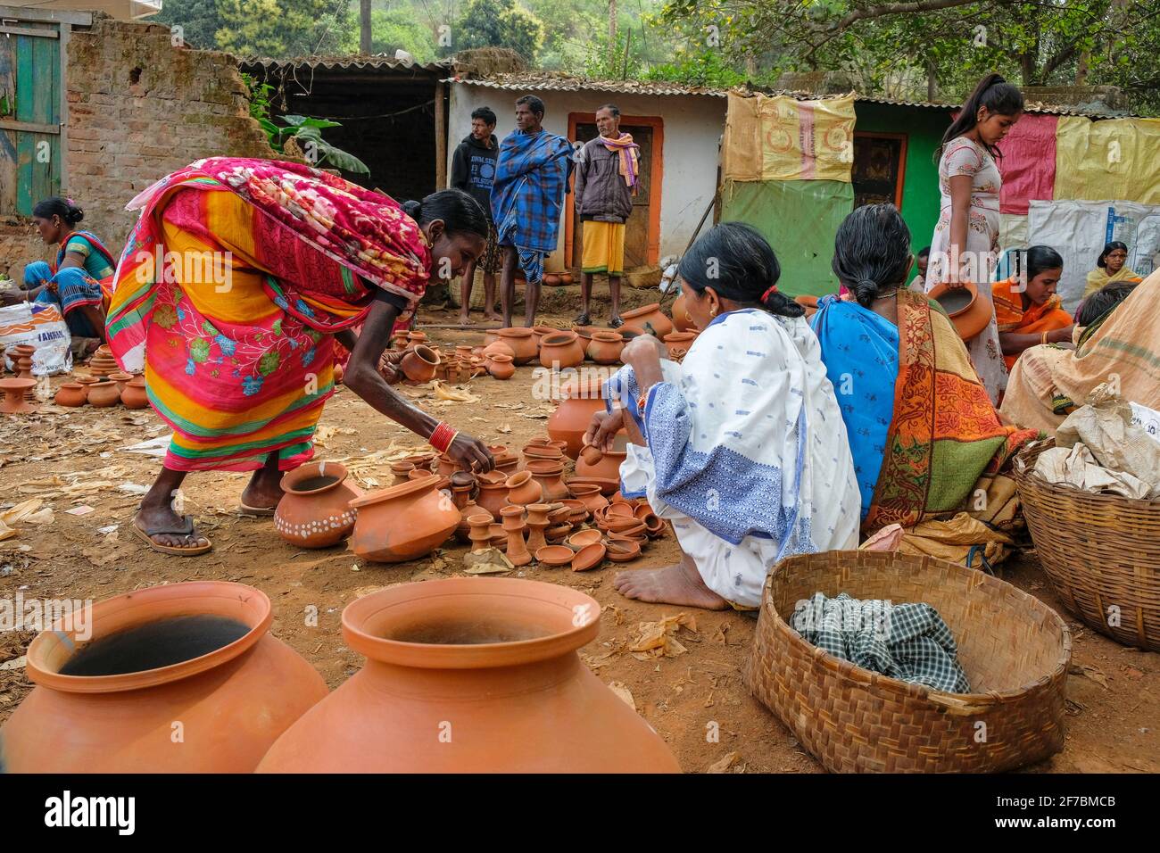 Kunduli, India - February 2021: Adivasi women from the Kondh tribe shopping for clay vases in the Kunduli market on February 19, 2021 in Odisha, India Stock Photo