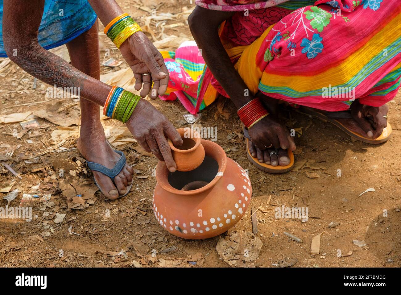Kunduli, India - February 2021: Adivasi women from the Kondh tribe shopping for clay vases in the Kunduli market on February 19, 2021 in Odisha, India Stock Photo