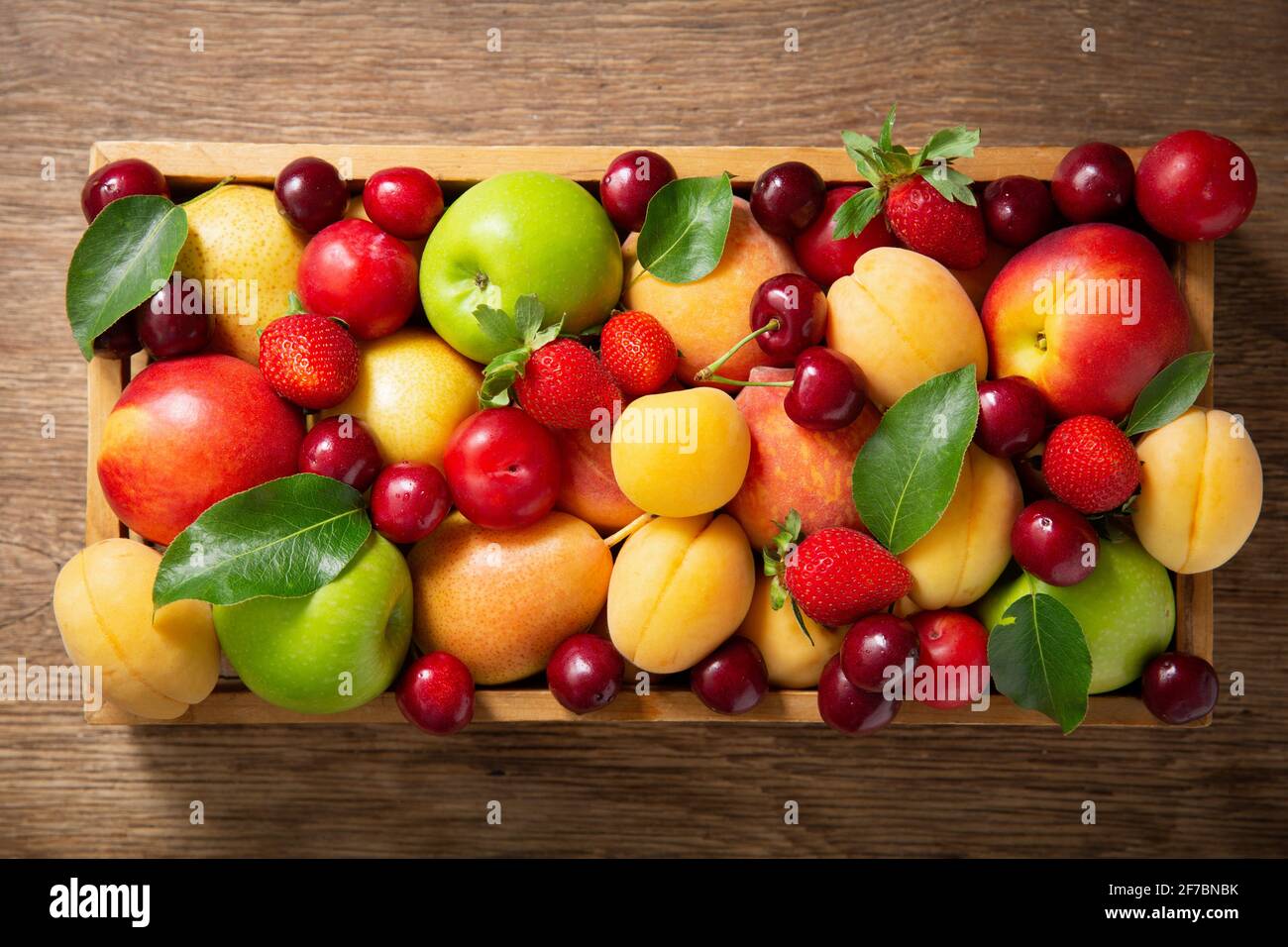 Variety of fruits in a wooden box hi-res stock photography and images ...