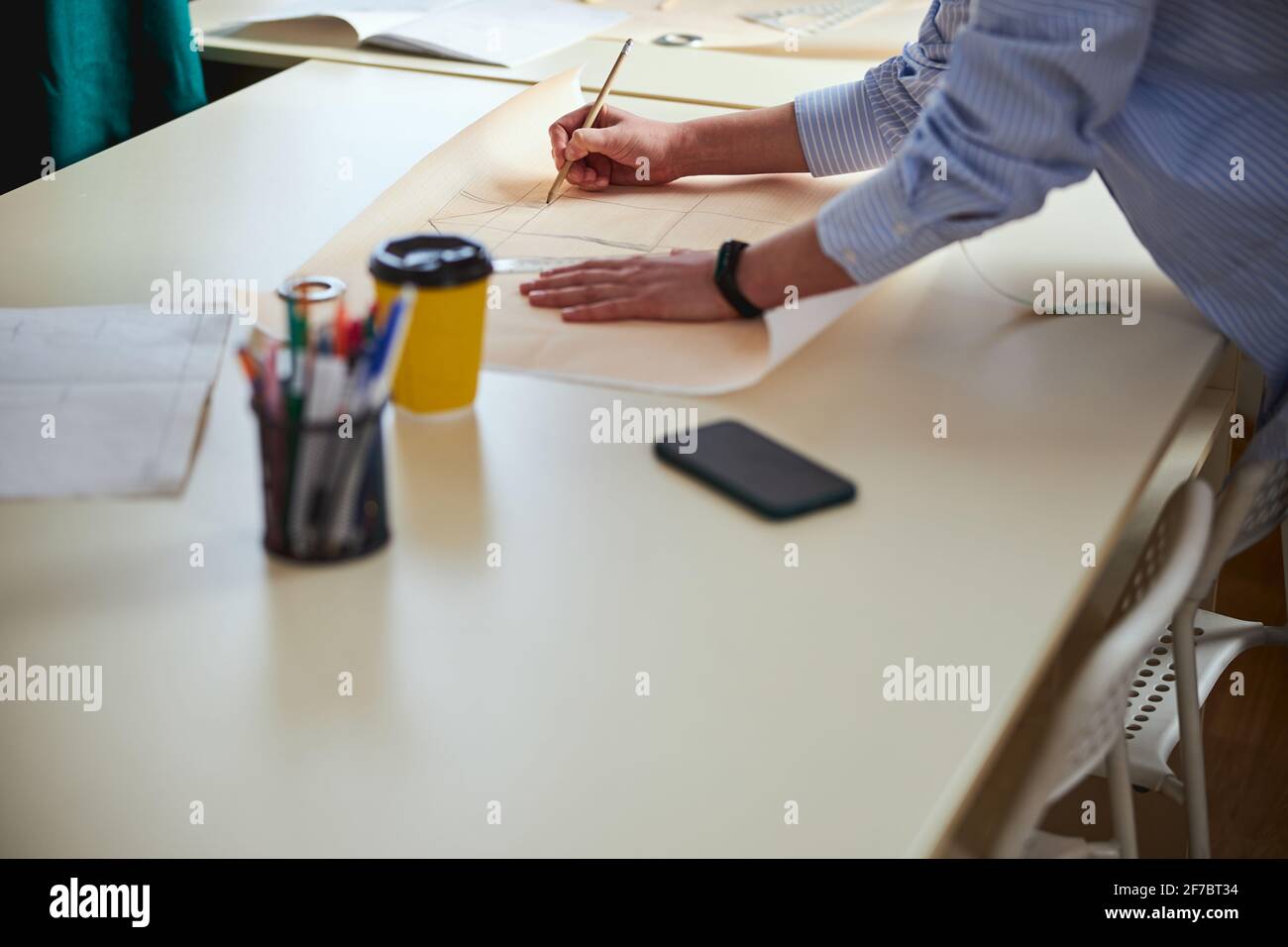 Pencil in hand of tailor used for drawing clothes sketch Stock Photo ...