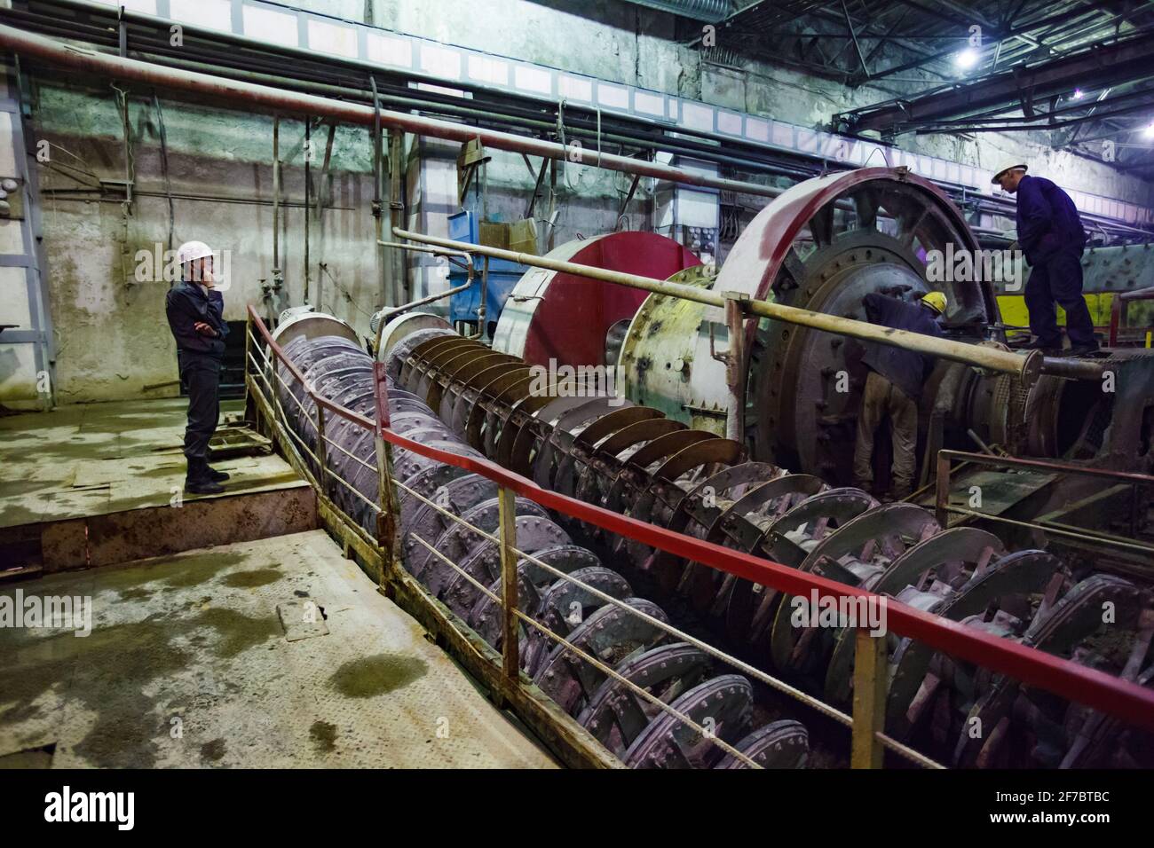 Stepnogorsk, Kazakhstan - April 04, 2012: Mill workshop of mining and processing plant. Ball mills and screw conveyor. (Spiral auger conveyor) and mai Stock Photo