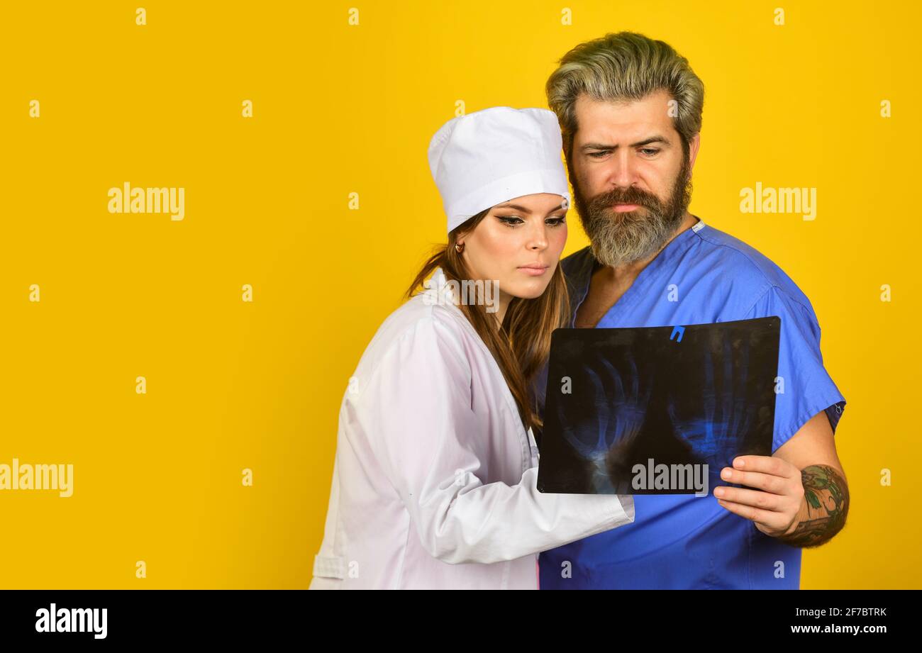 Diagnostics bone damage. Doctor discussing x ray snap with colleague