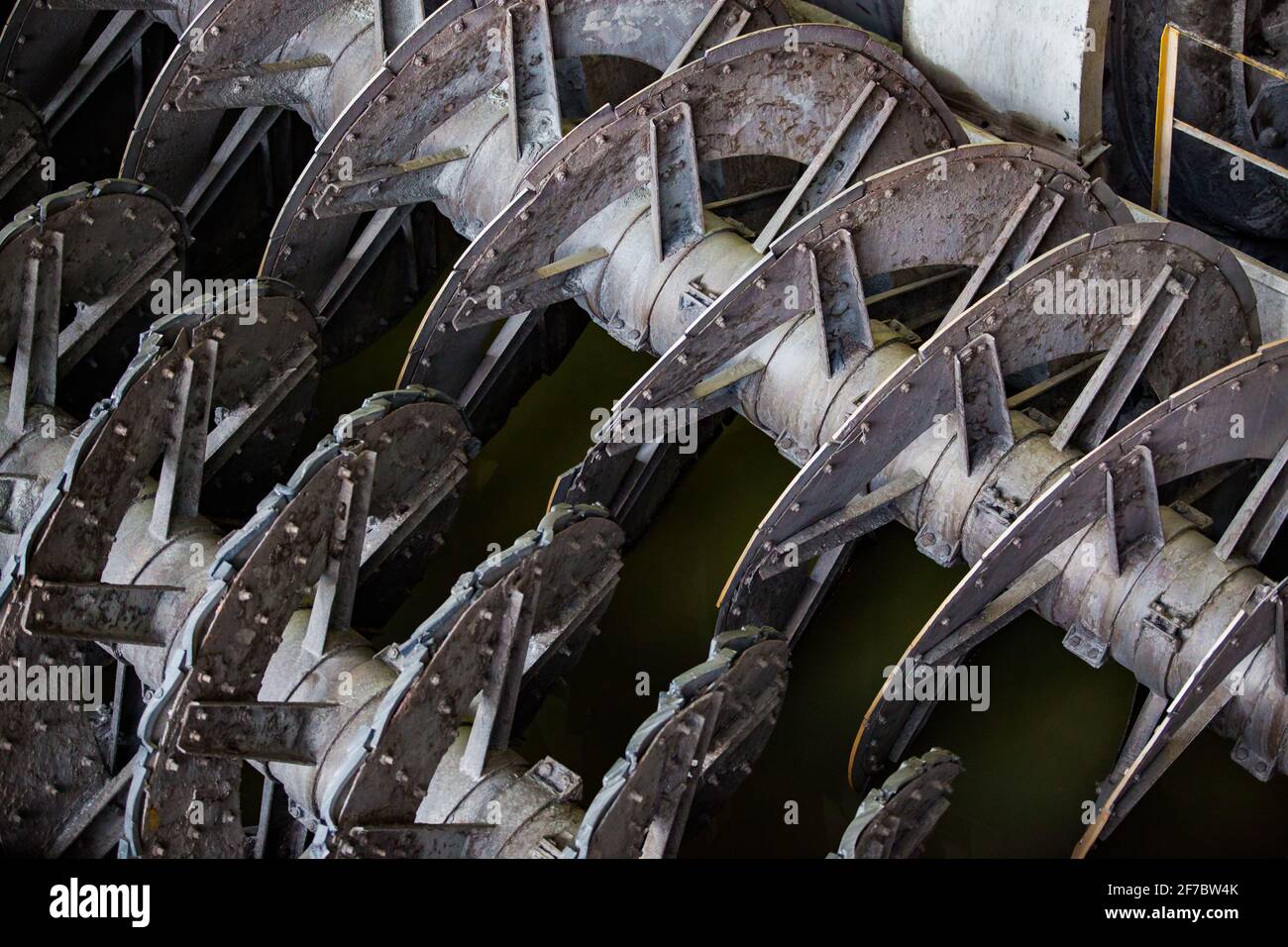 Screw conveyor close-up. Ore concentration plant. Focus on upper spiral. Stock Photo
