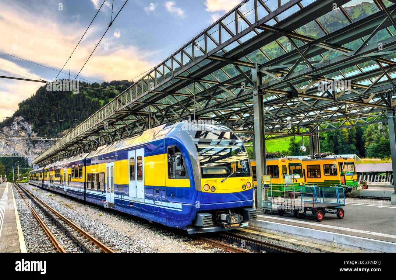 Passenger trains at Lauterbrunnen railway station in Switzerland Stock Photo