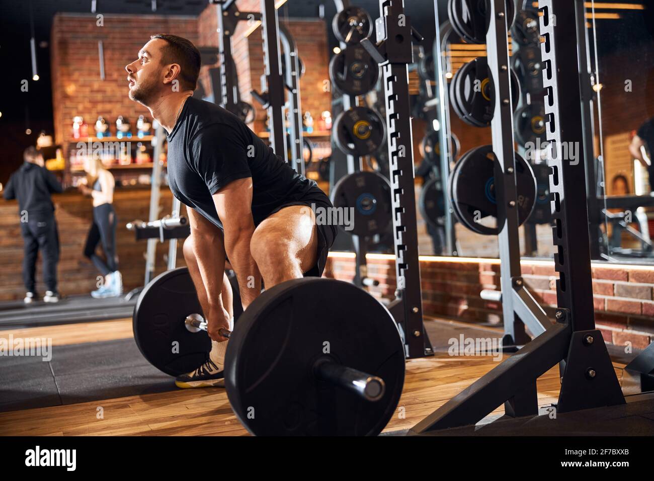 Dedicated male bodybuilder doing weightlifting at the gym Stock Photo
