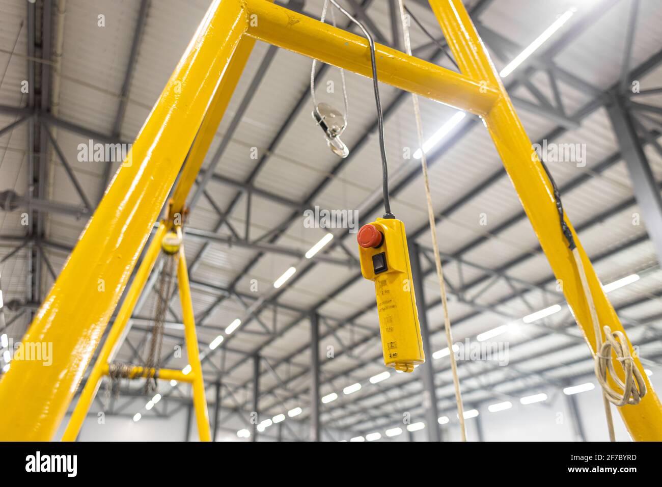 Close up red button. Swivel electric crane hook for overhead crane in