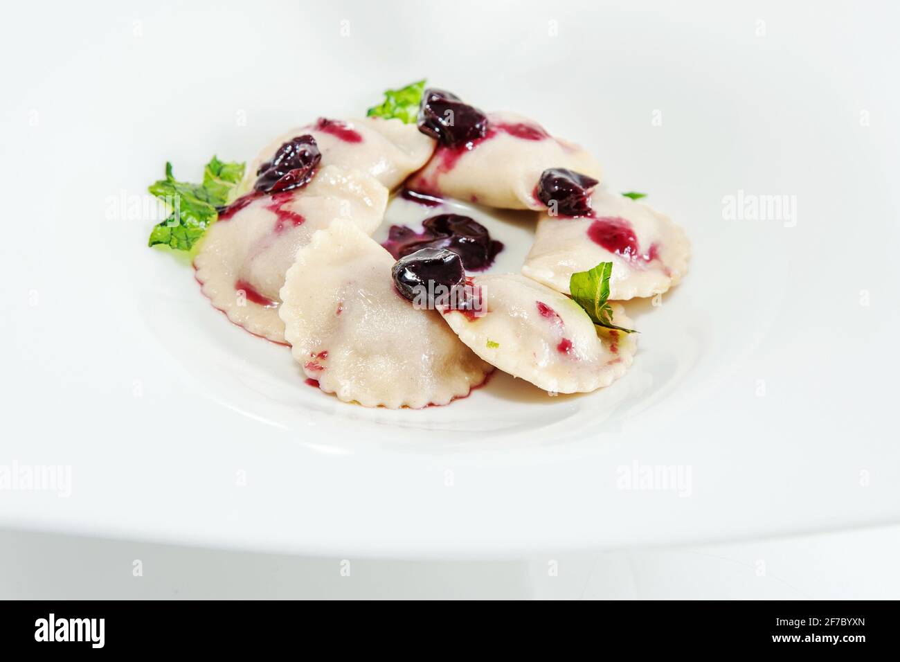 Ravioli stuffed with cheese fondue and served with stewed grapes, Lazio, Italy, Europe Stock Photo