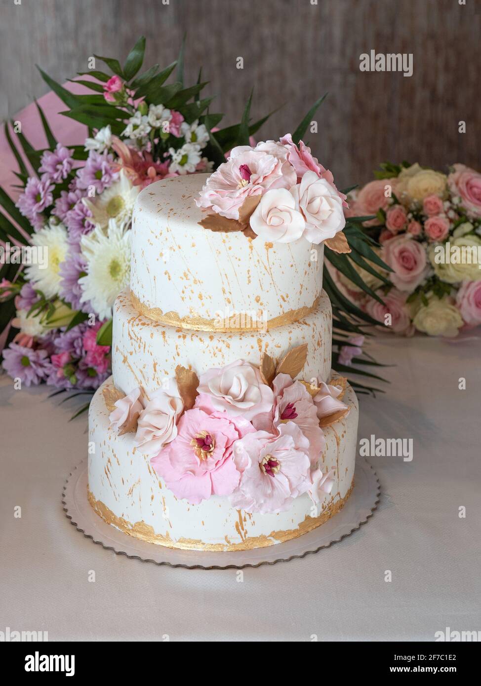 Beautiful wedding cake with flowers in several layers Stock Photo - Alamy