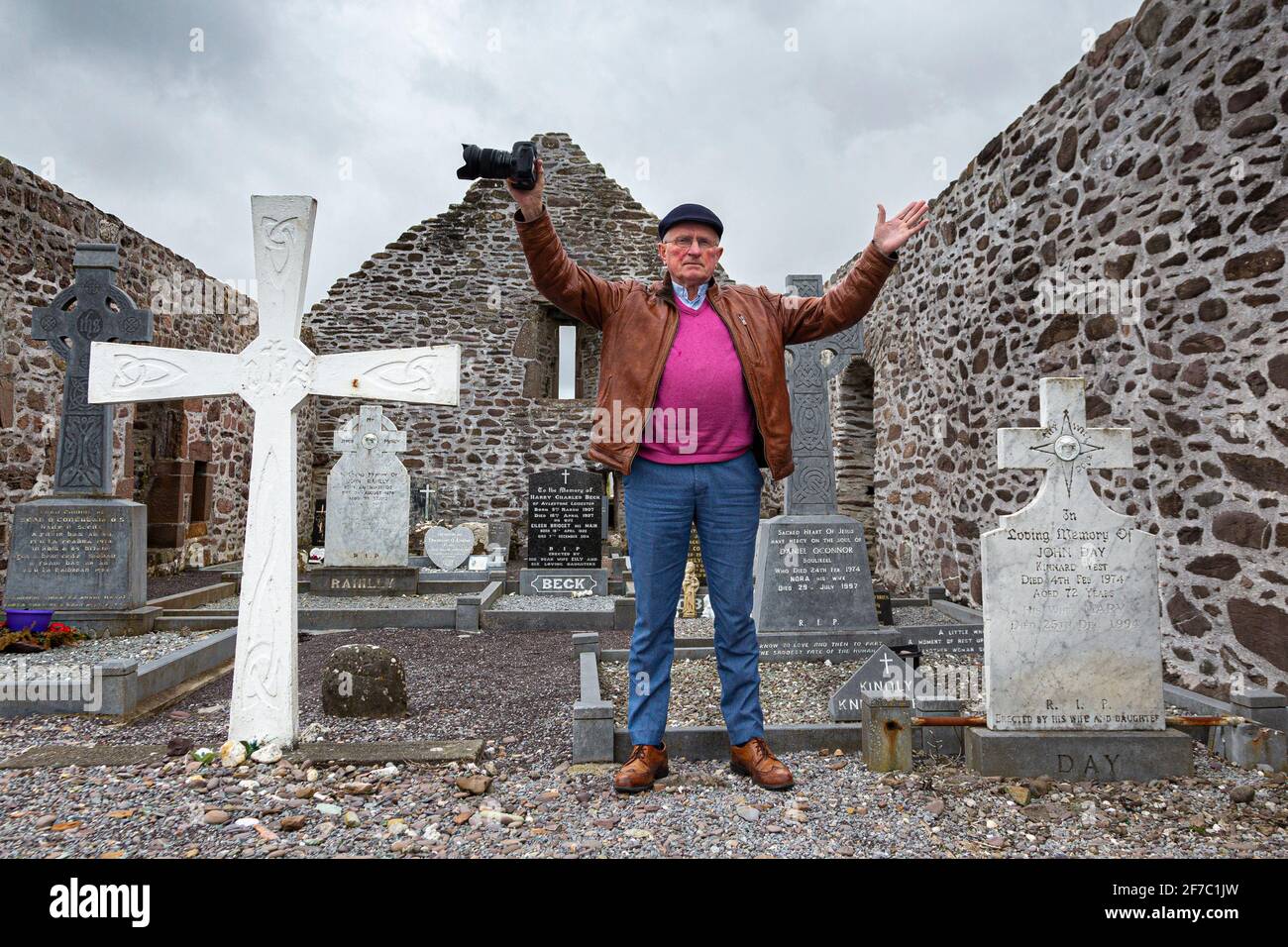 Senior citizen in churchyard, being positive about life Stock Photo