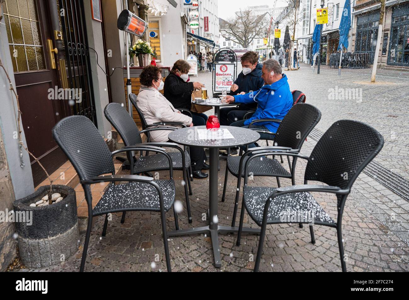 06 April 2021, Saarland, Saarbrücken: Guests sit in front of the pub 'Glühwürmchen' in downtown Saarbrücken. As of today, restaurateurs are allowed to reopen their outdoor restaurants under certain conditions within the framework of the Saarland Model. Photo: Oliver Dietze/dpa Stock Photo