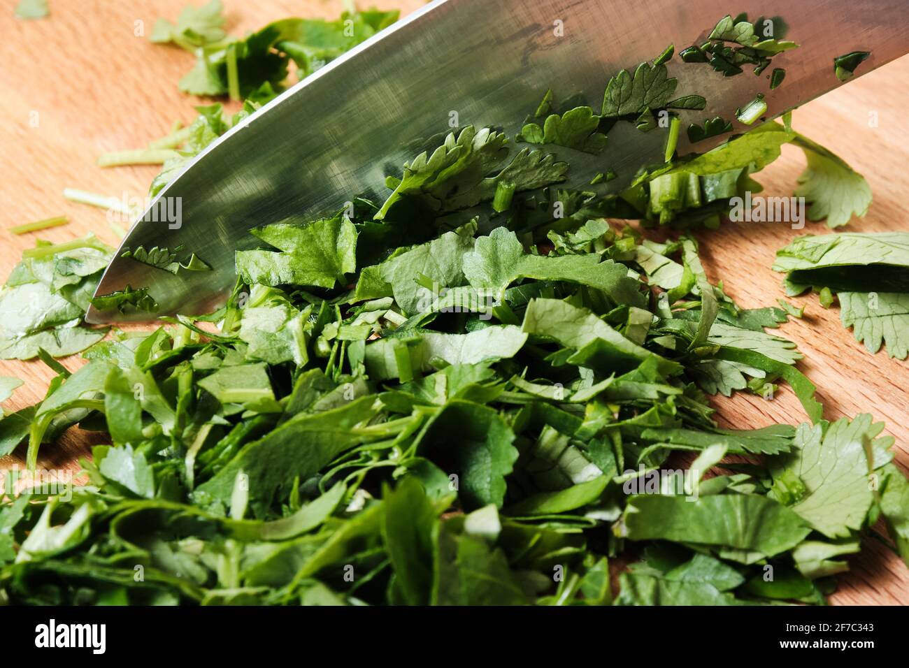 Chopping parsley on a cutting board Stock Photo