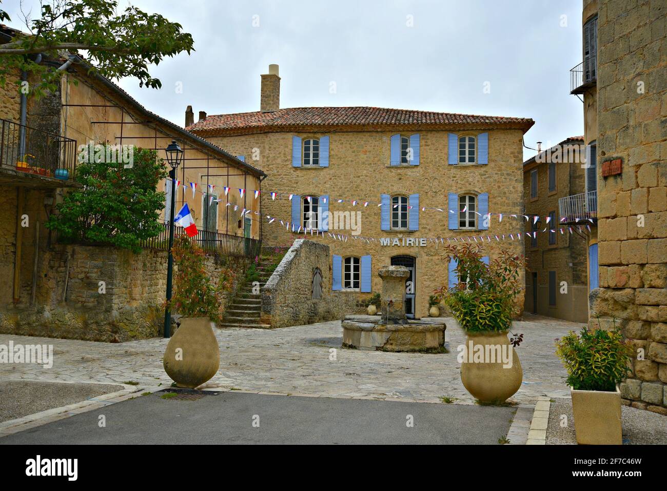 Scenic exterior view of the Provençal  style City Hall on the main square of Grambois in Provence-Alpes-Côte d'Azur Vaucluse, France. Stock Photo
