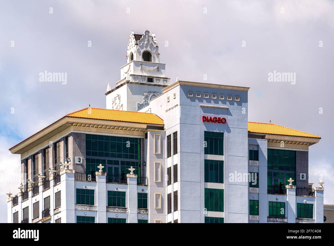 Mediterranean Revival commercial building in Coral Gables with ornate tower and yellow tiled roof, Miami, Florida, USA Stock Photo