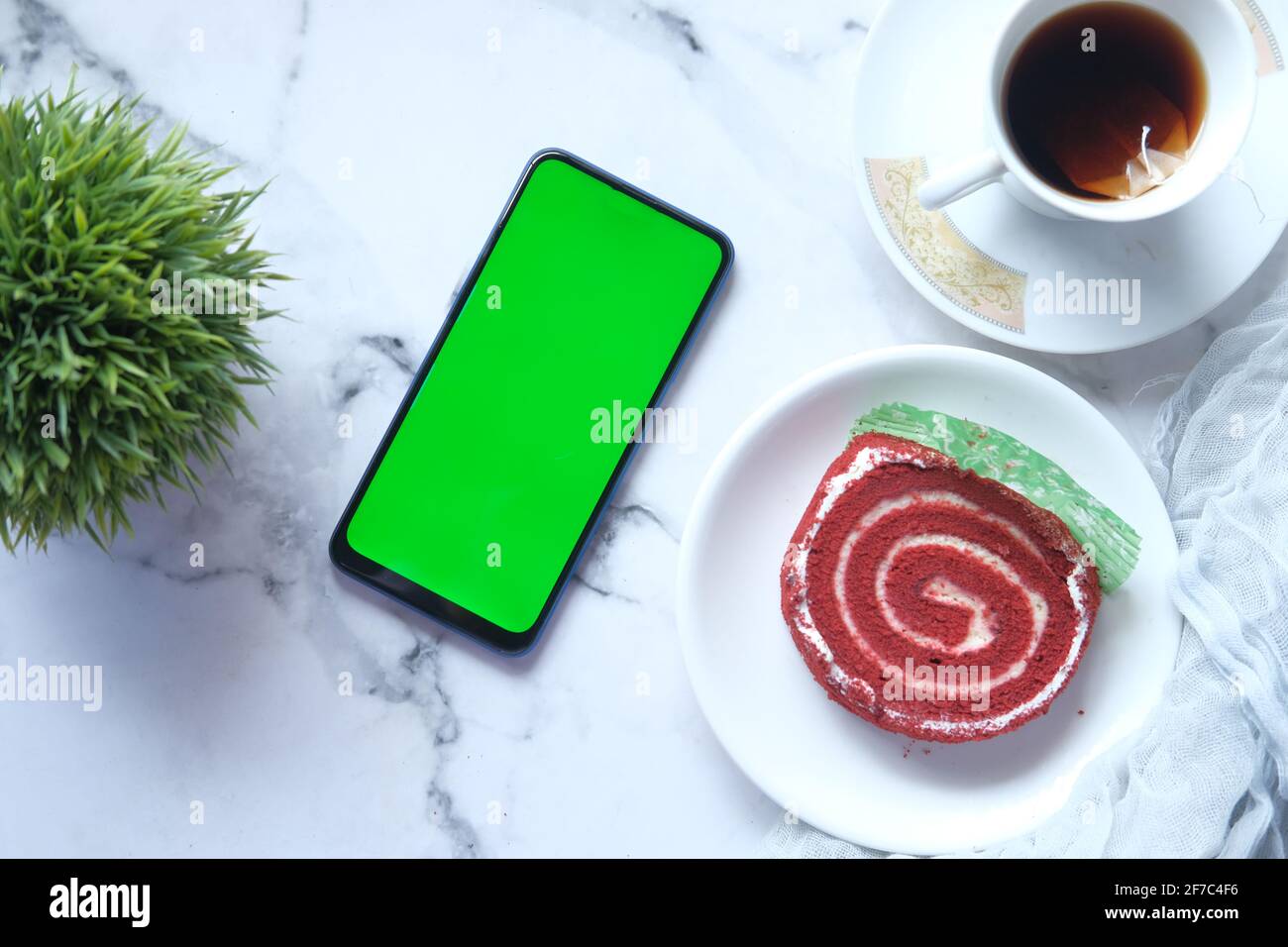 top view of smart phone, tea and a cake on tiles background Stock Photo ...