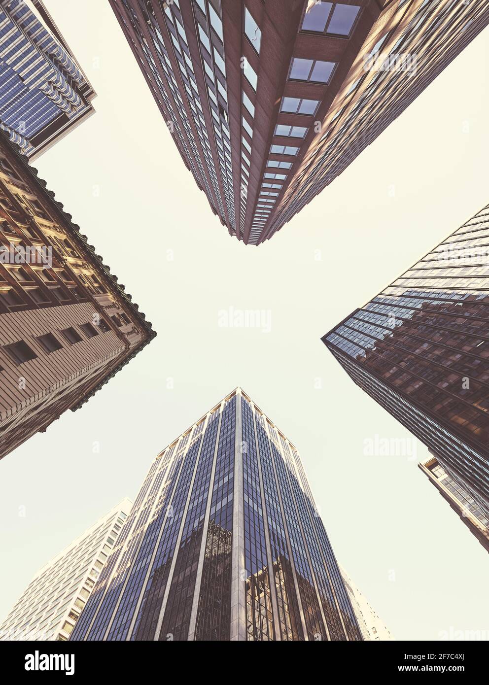 Looking up at Manhattan skyscrapers, color toned picture, New York City, USA. Stock Photo