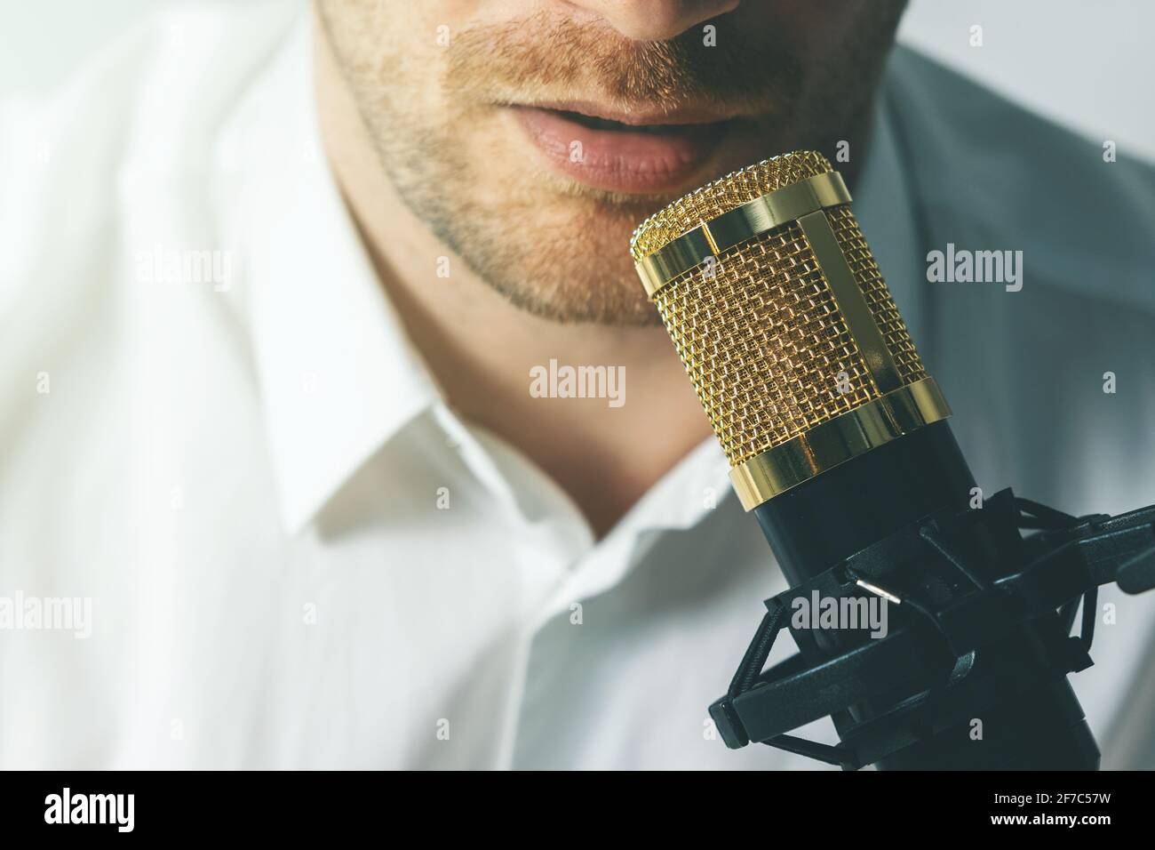 young man recording podcast. speaking in microphone closeup Stock Photo