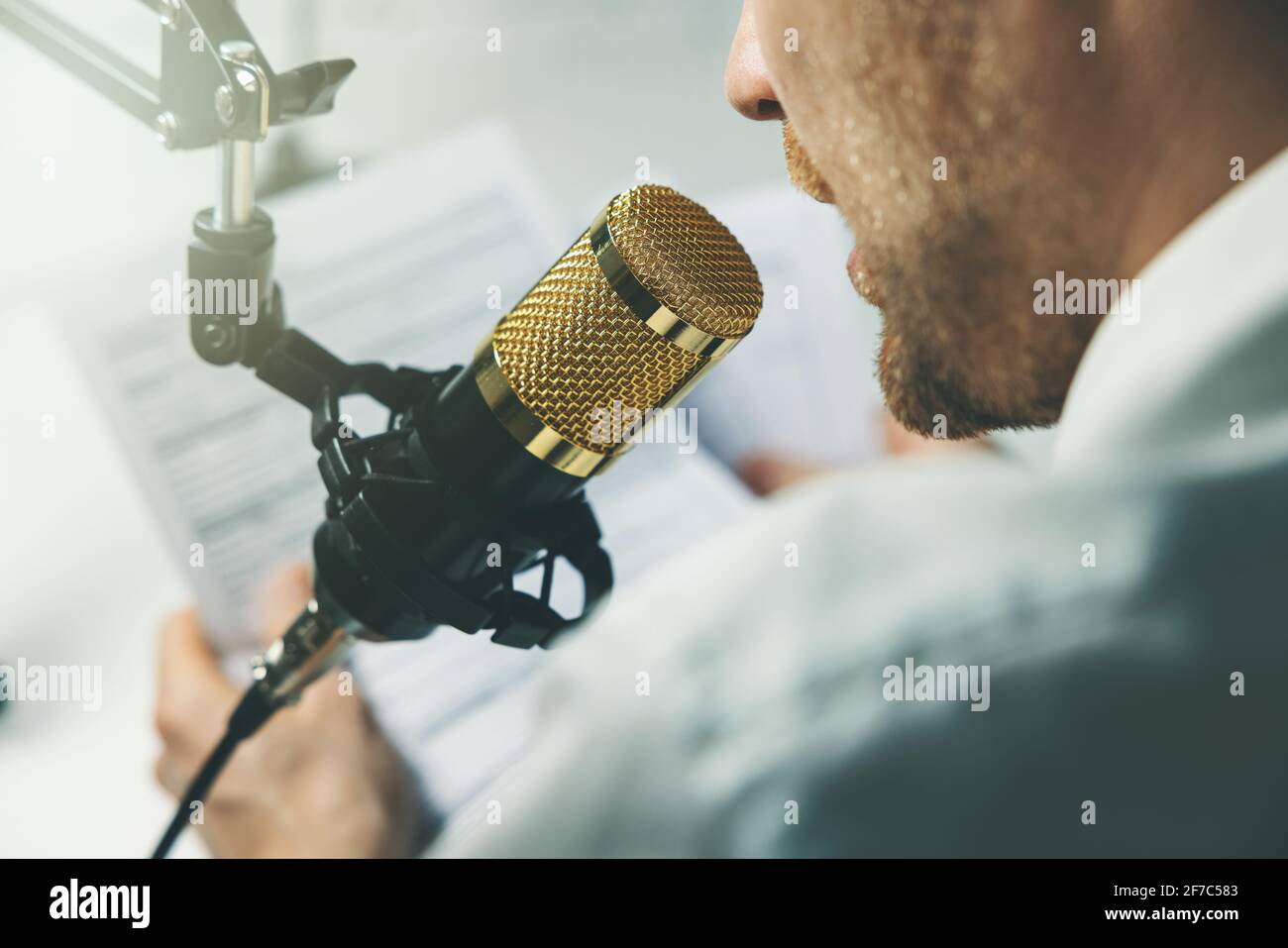 business podcast, online seminar. businessman speaking in microphone Stock Photo