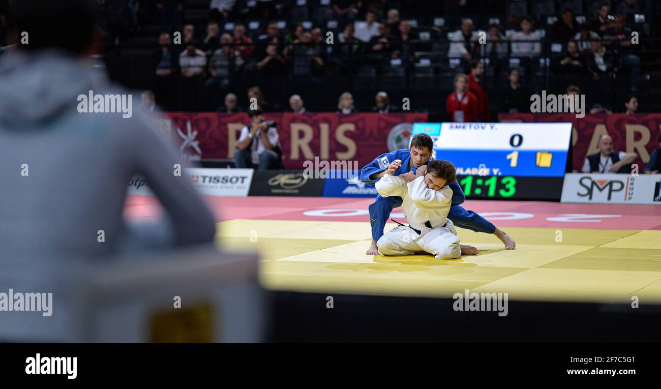 Yeldos Smetov (white) of Uzbekistan and Yago Abuladze of Russia compete in the semi-final of the Paris Grand Slam judo tournament on Feb. 9, 2020. Stock Photo