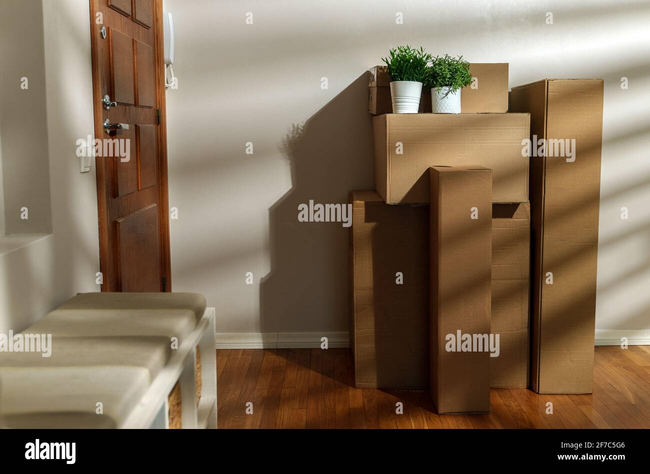 New home concept. Boxes in empty room near the entrance door Stock ...