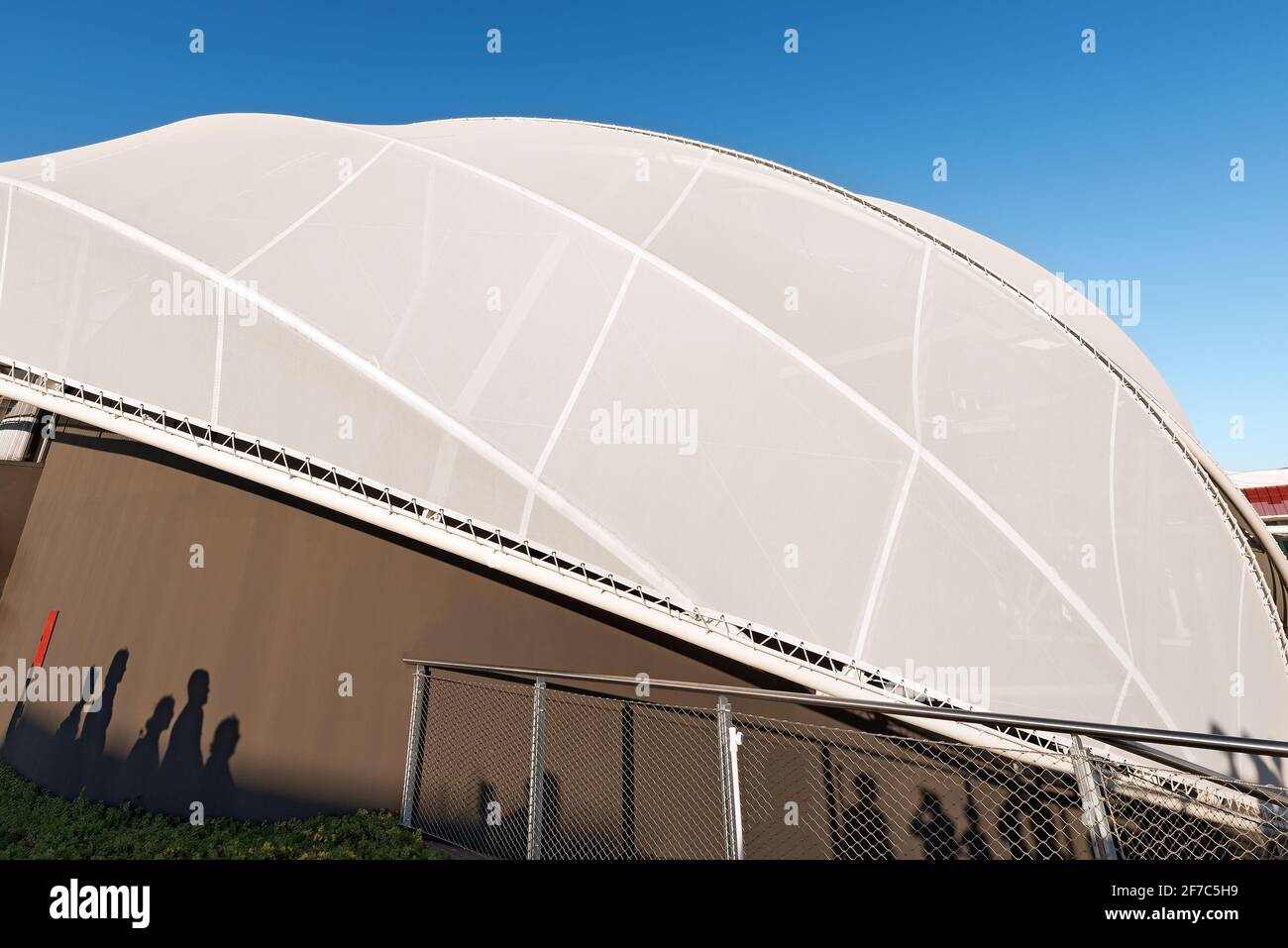 Close-up of a modern tensile structure on a clear blue sky, membrane ...