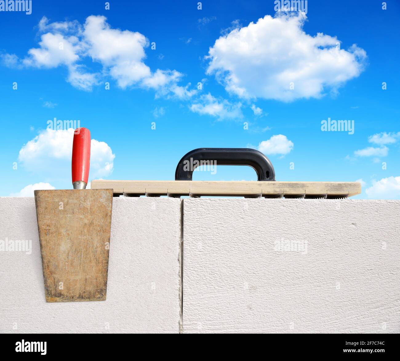 Masonry tools on brick wall. Bricklaying work Stock Photo Alamy