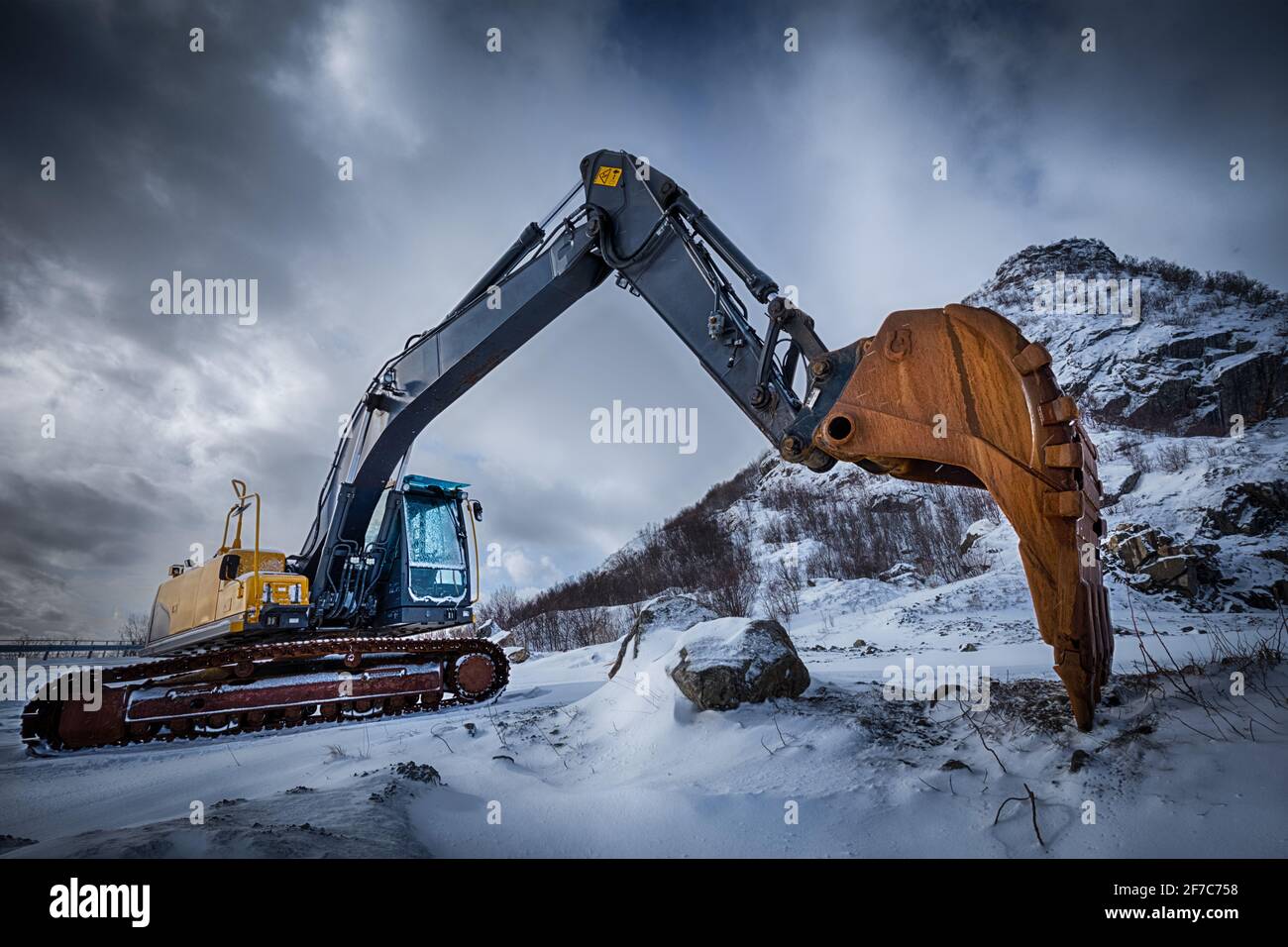 Old excavator in winter landscape Stock Photo