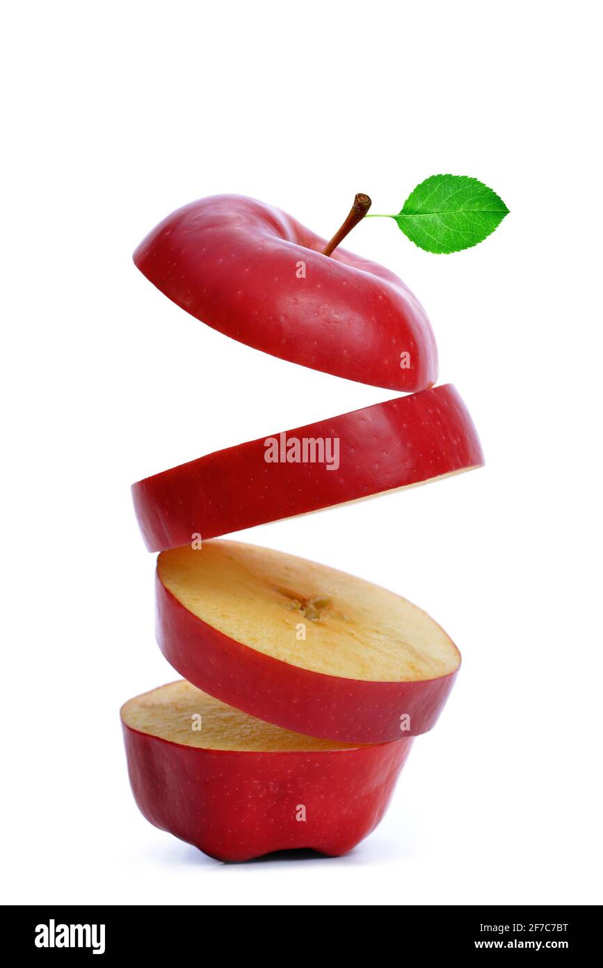 Sliced red apple with green leaf isolated on white background. Stock Photo