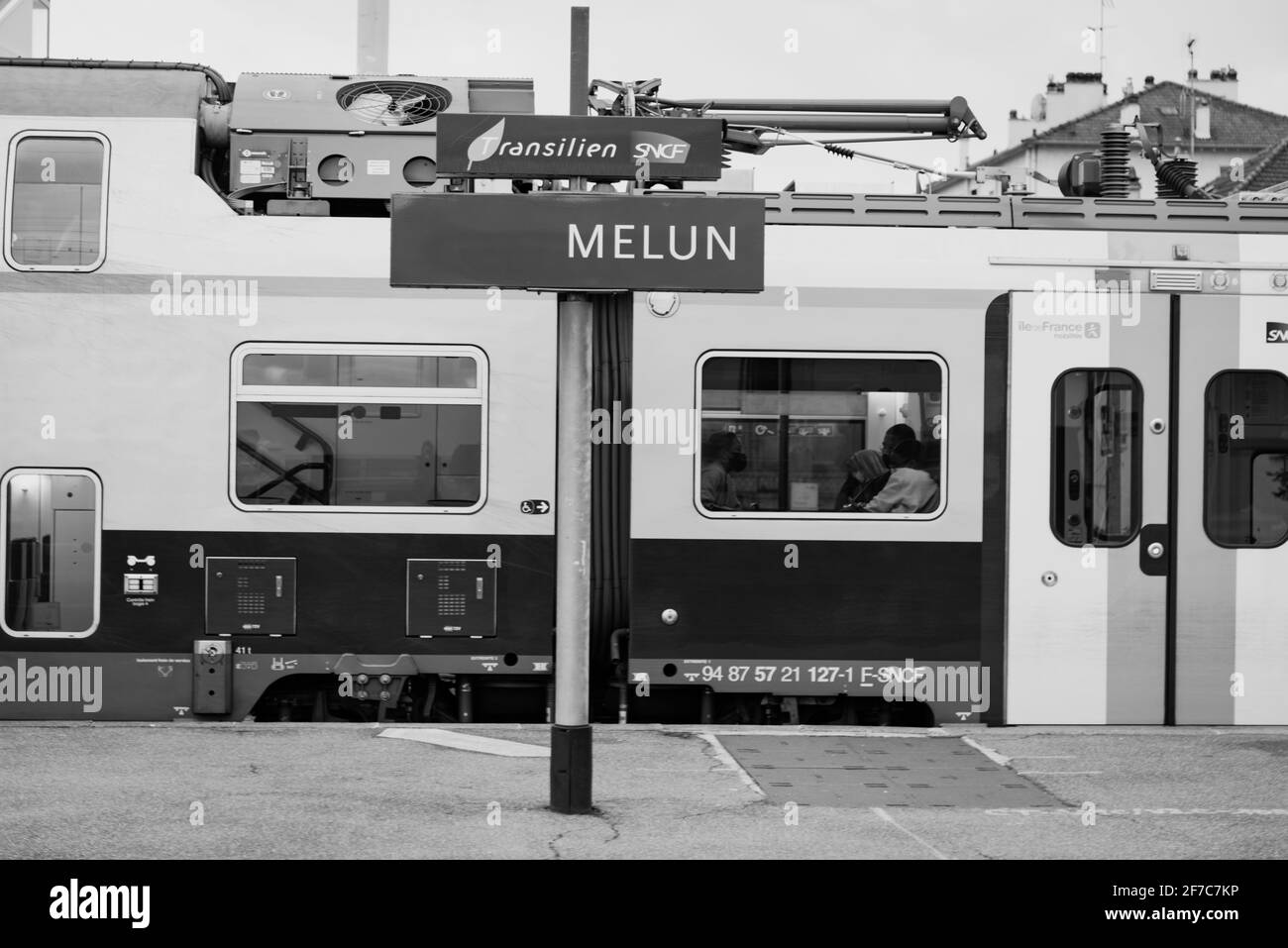 Melun, France - October 3, 2020: People wearing protective masks against Covid-19 at train station as part of reinforced health measures. Black white Stock Photo
