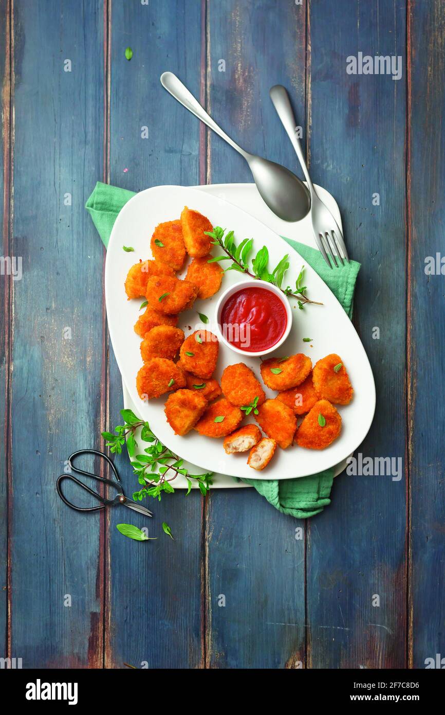 Chicken nuggets with paprika and ketchup Stock Photo Alamy