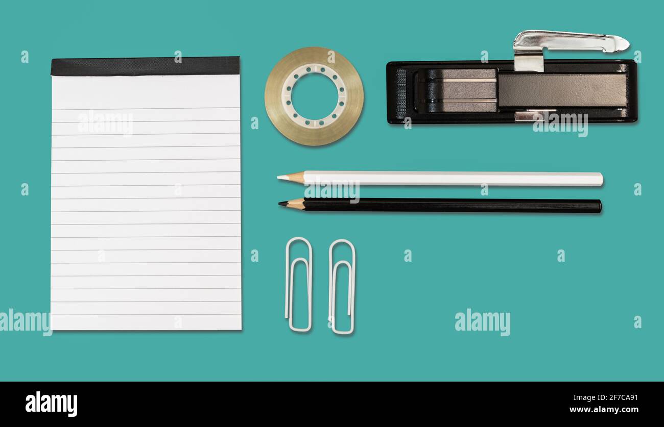 Office and school stationery on cyan background. Flat lay. Stock Photo