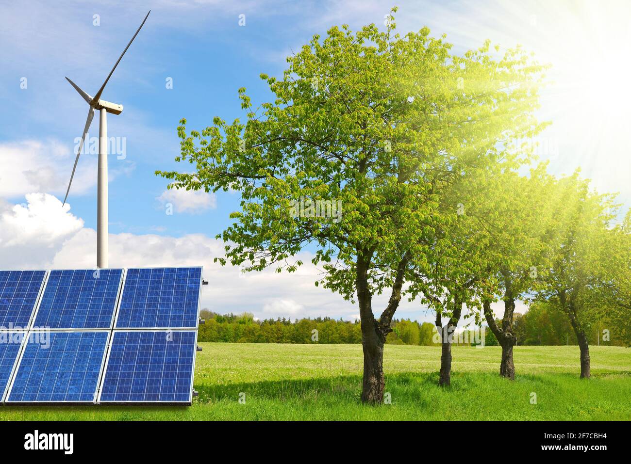 Solar panels with wind turbine on the meadow. Power plant generate