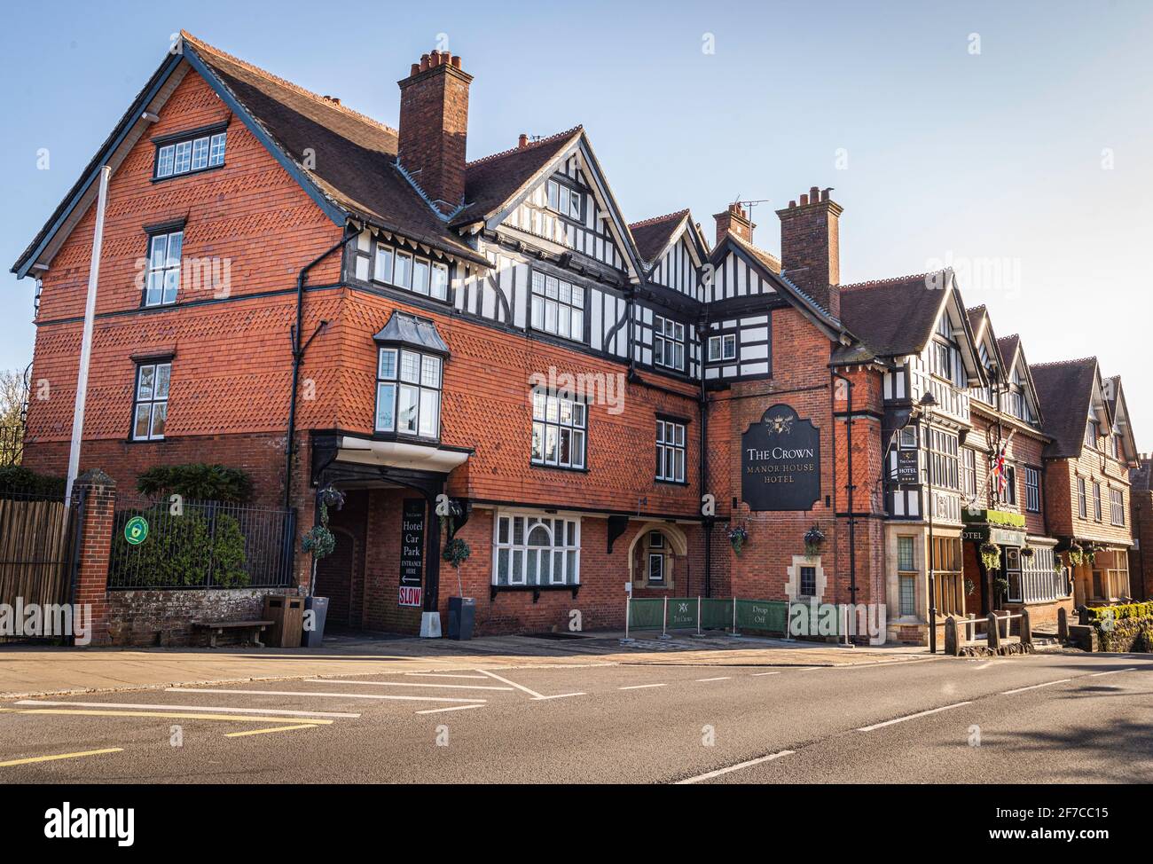 The Crown Manor House Hotel, 15th Century building on a sunny day with clear blue sky no people or traffic. Located in Lyndhurst Village, Hampshire Stock Photo
