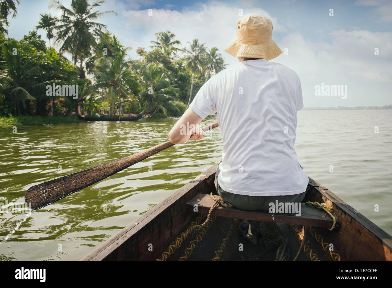 Man traveling to Kerala backwaters, floating on the boat and enjoying beautiful view landscape, Alappuzha, India Stock Photo