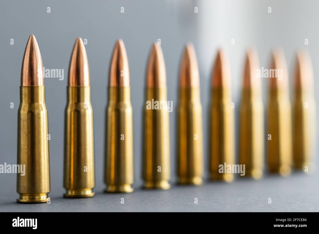 Bullets on gray background. Cartridges 7.62 caliber for Kalashnikov ...
