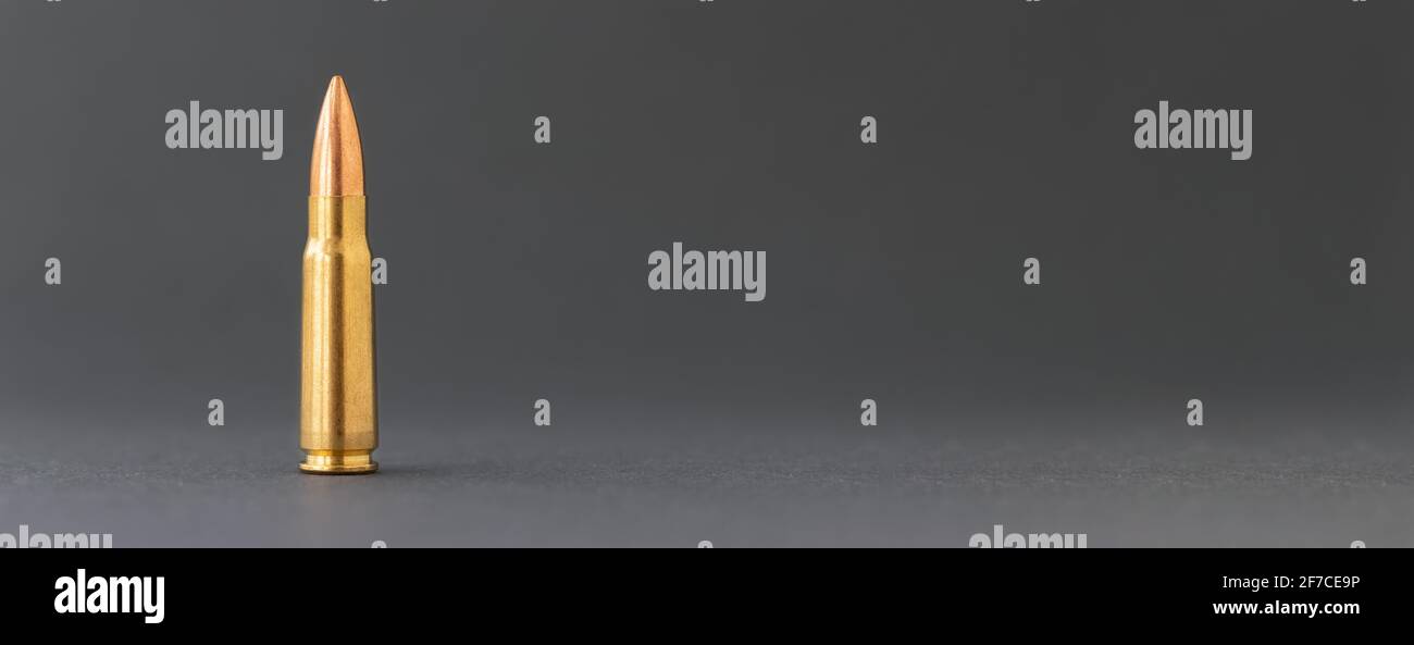 Bullet on gray background. Cartridge 7.62 caliber for Kalashnikov ...