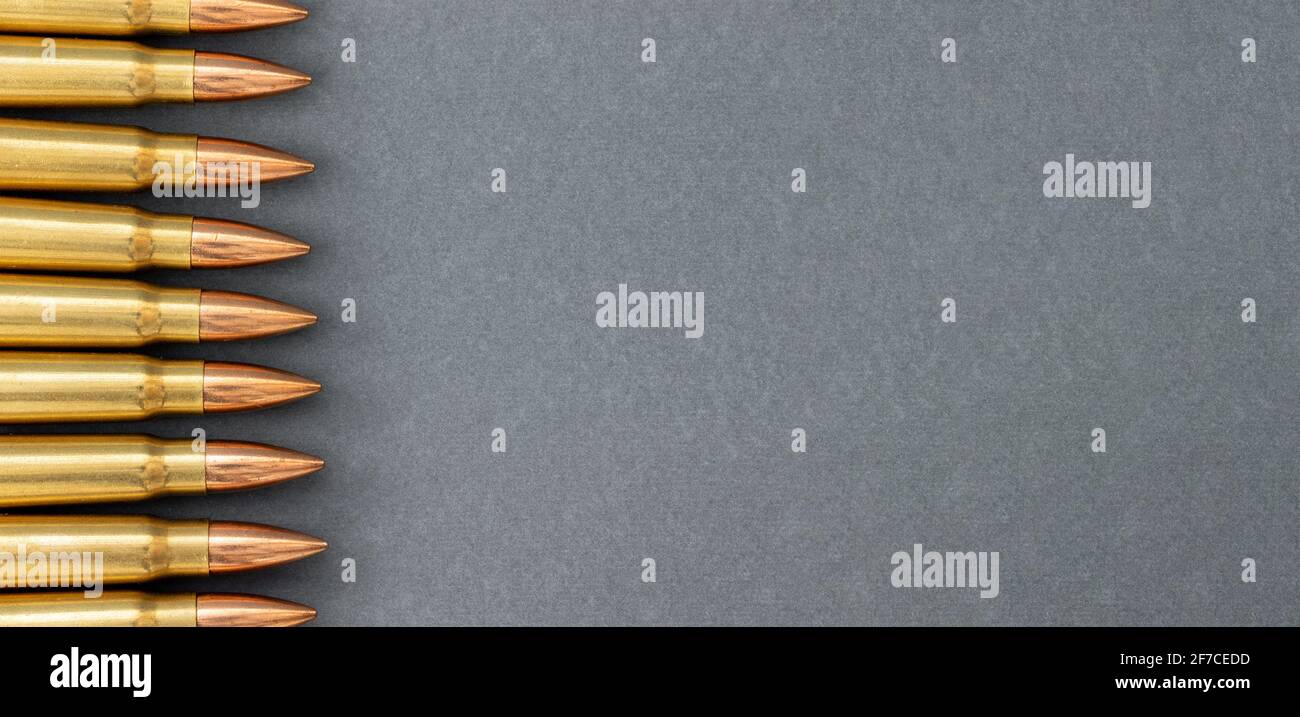 Bullets on gray paper background. Cartridges 7.62 caliber for ...